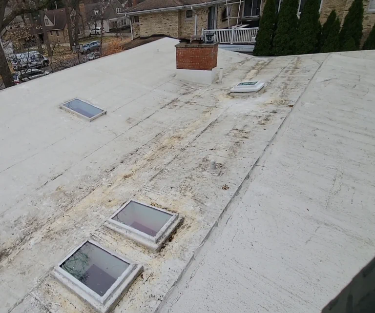 a debris free, flat roof after roof cleaning with the acorns and leaves placed into garbage bags