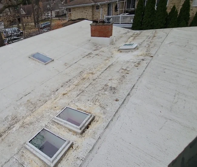 a debris free, flat roof from a higher altitude view after roof cleaning